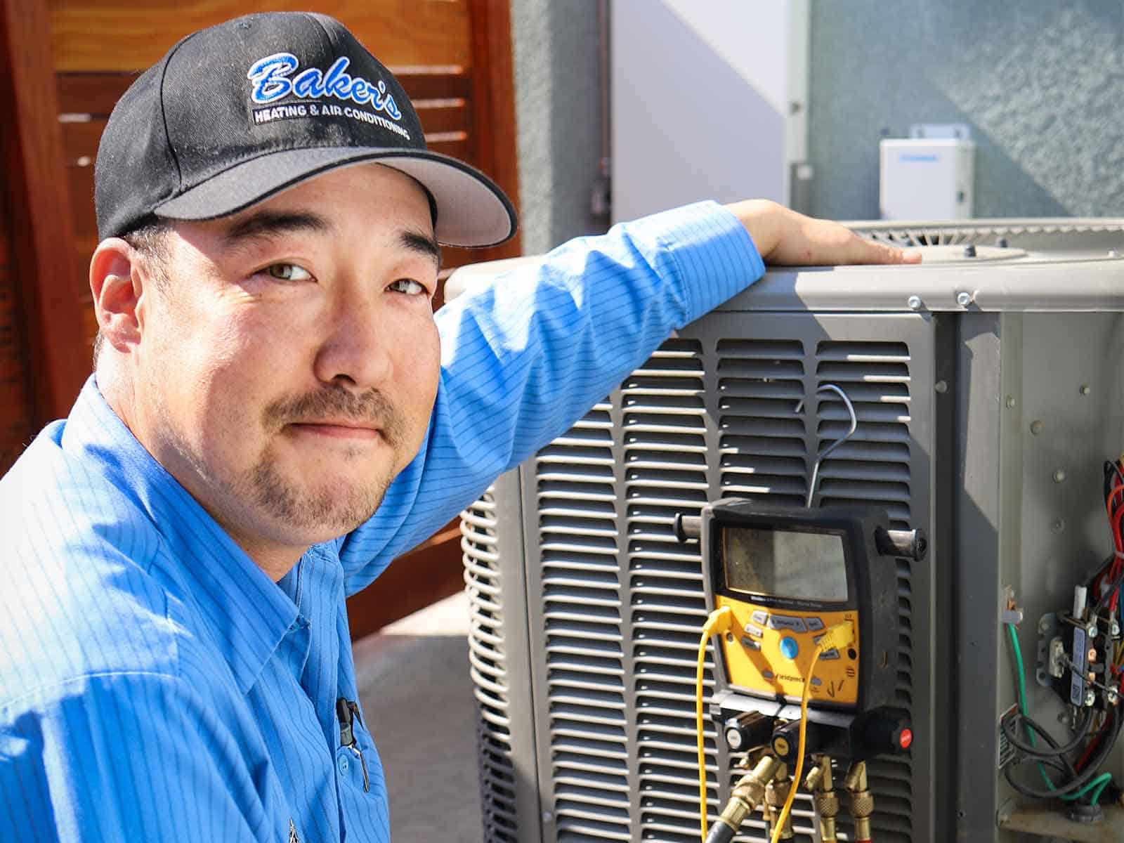 Professional AC technician servicing air conditioner in Lodi CA - Baker's HVAC repair and maintenance since 1975